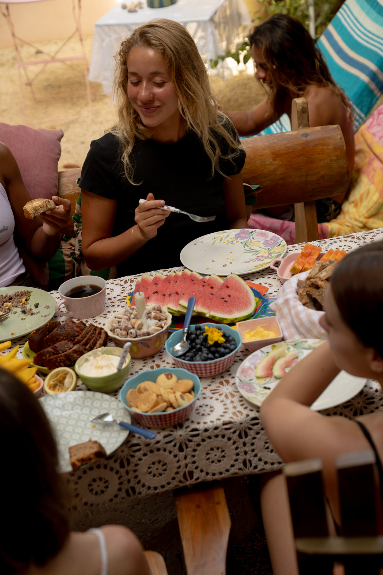 Friends sharing breakfast together around the table