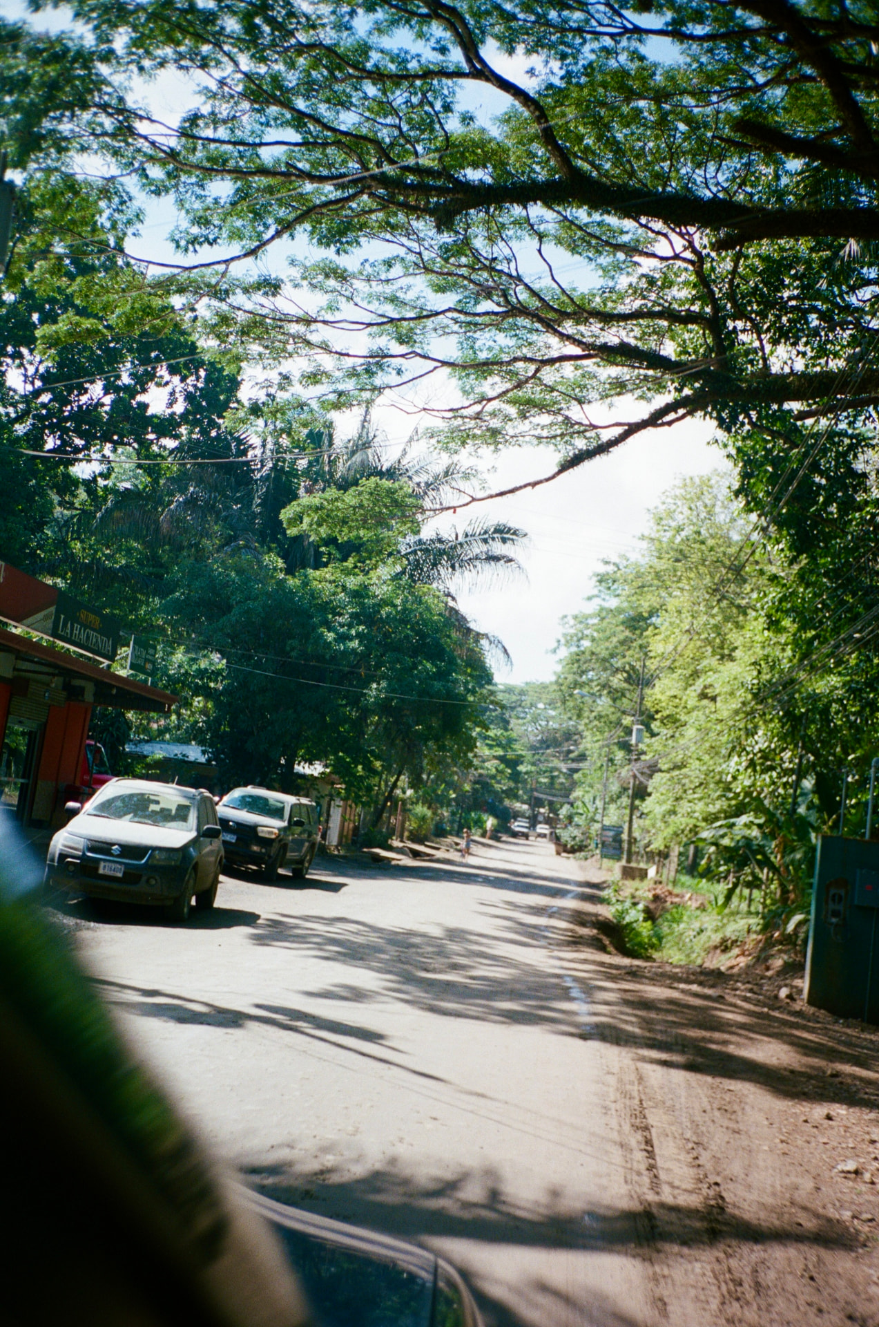 The sandy road through town with cafés and grocery stores