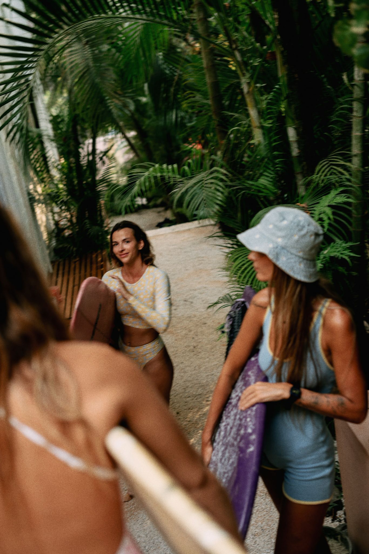 Retreat guests walking together with surfboards