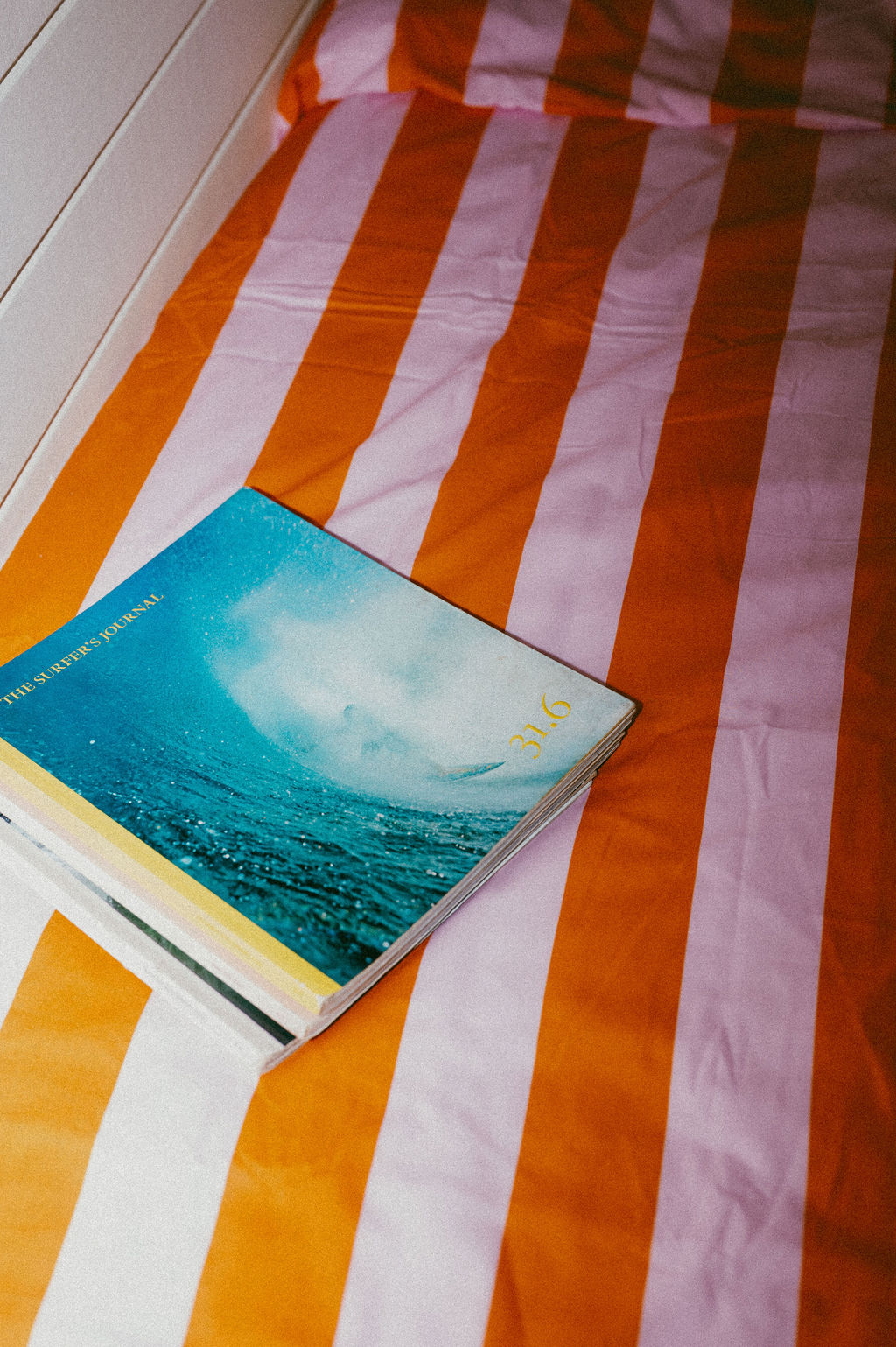 Surf journals on a striped bedspread