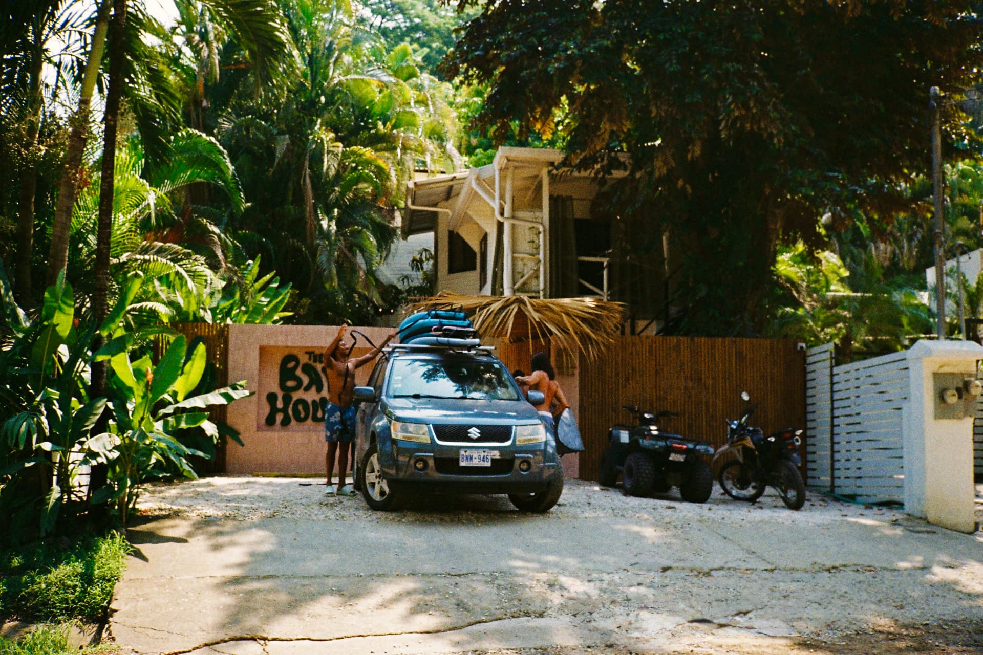 Arriving at The Baya House — unloading surfboards out front