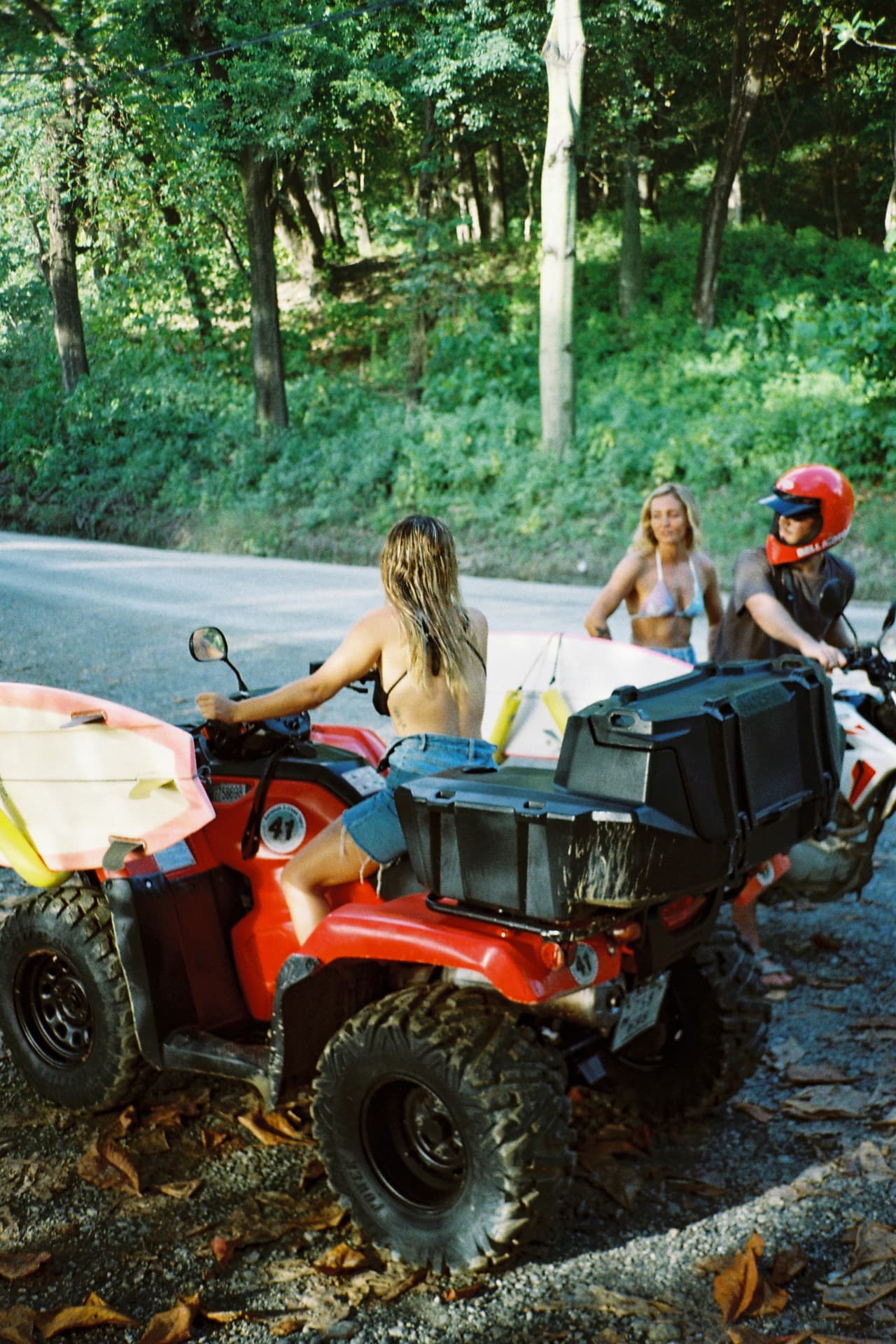 Heading out on an ATV loaded with surfboards