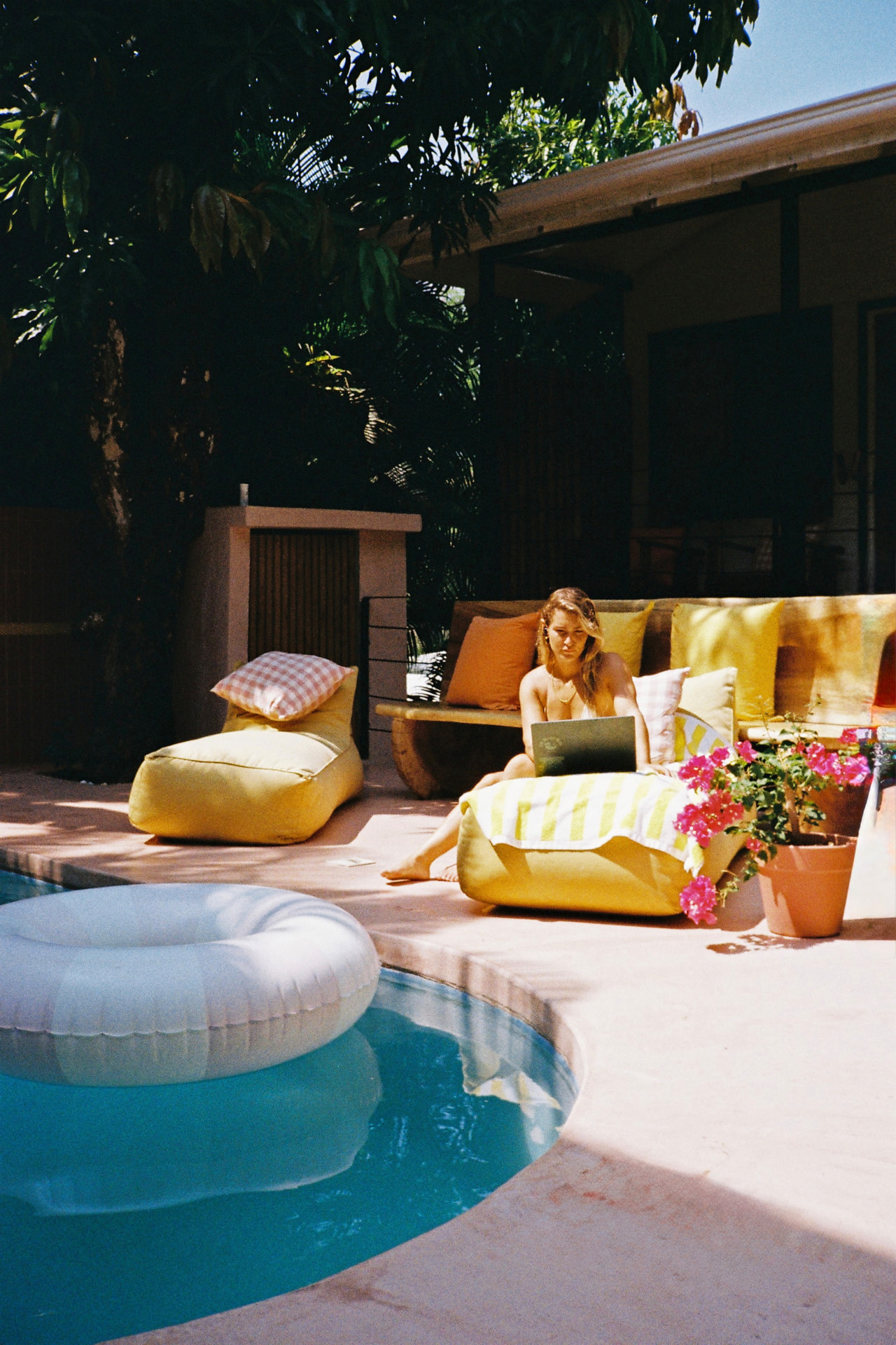 Working poolside on the yellow lounger
