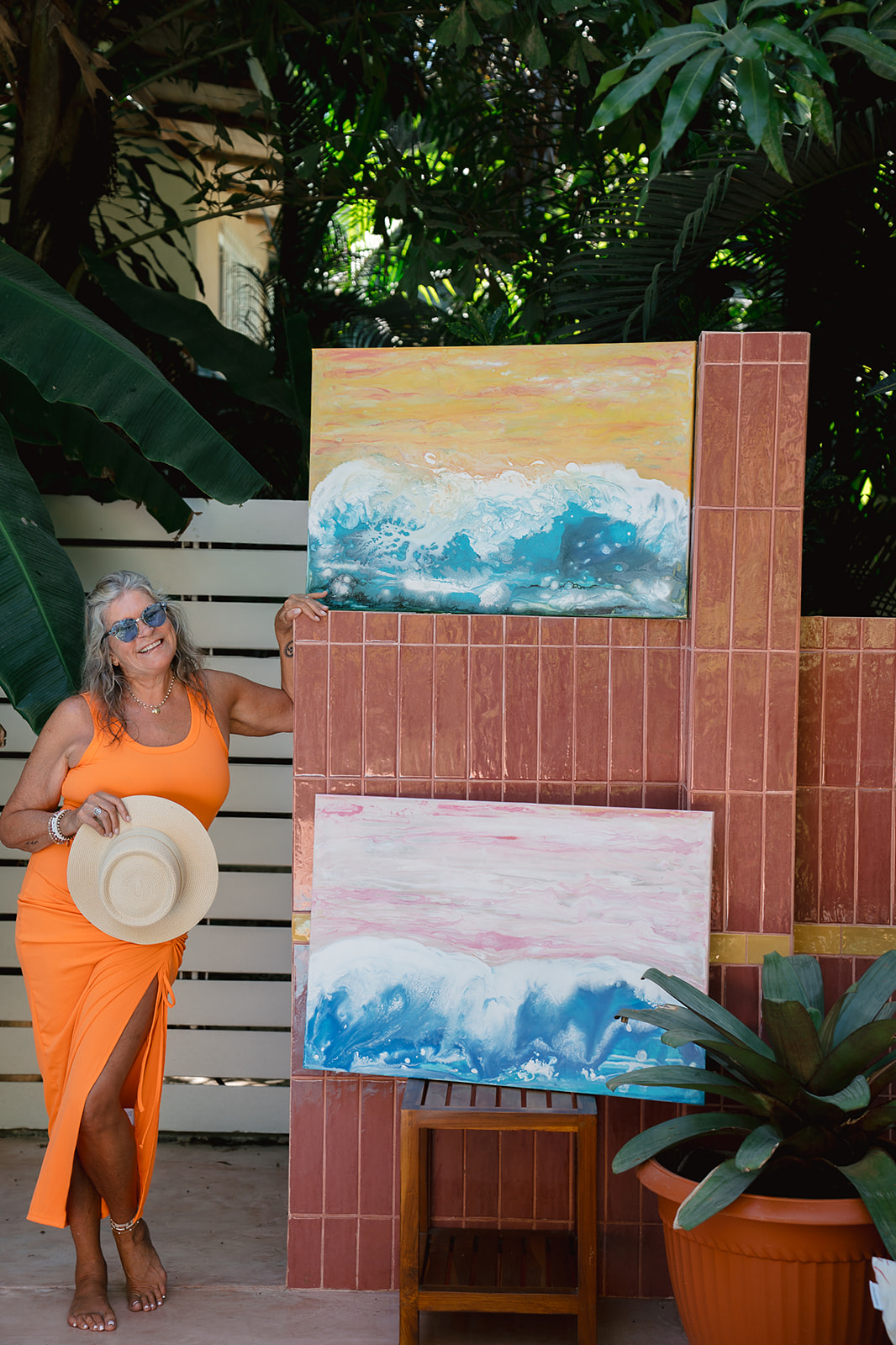 Lori Burke with her wave paintings at The Baya House